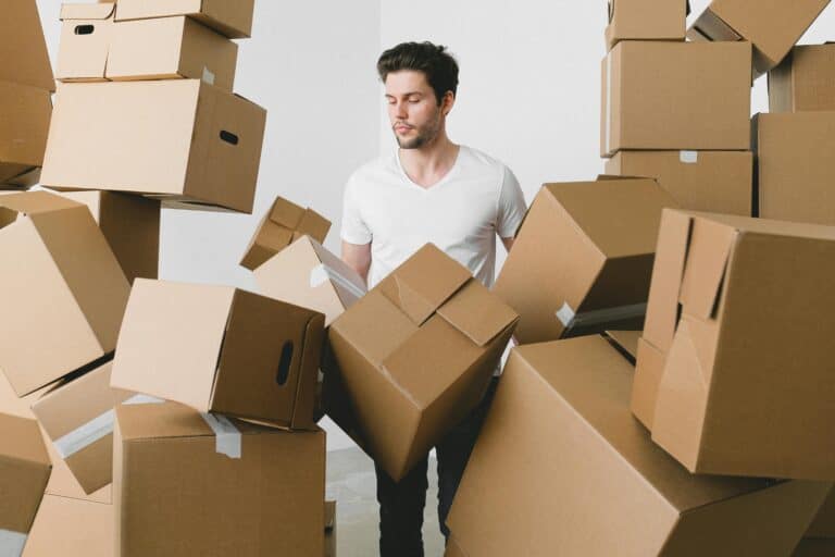 a man standing in a pile of cardboard boxes